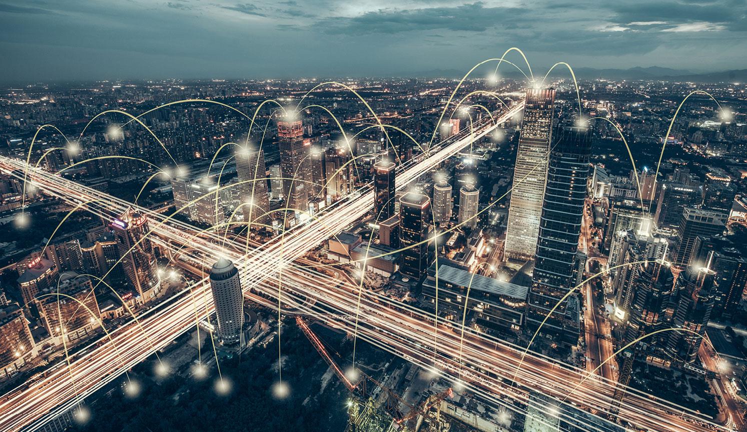 busy city view of skyscrapers at night, with light trail connections going from point to point